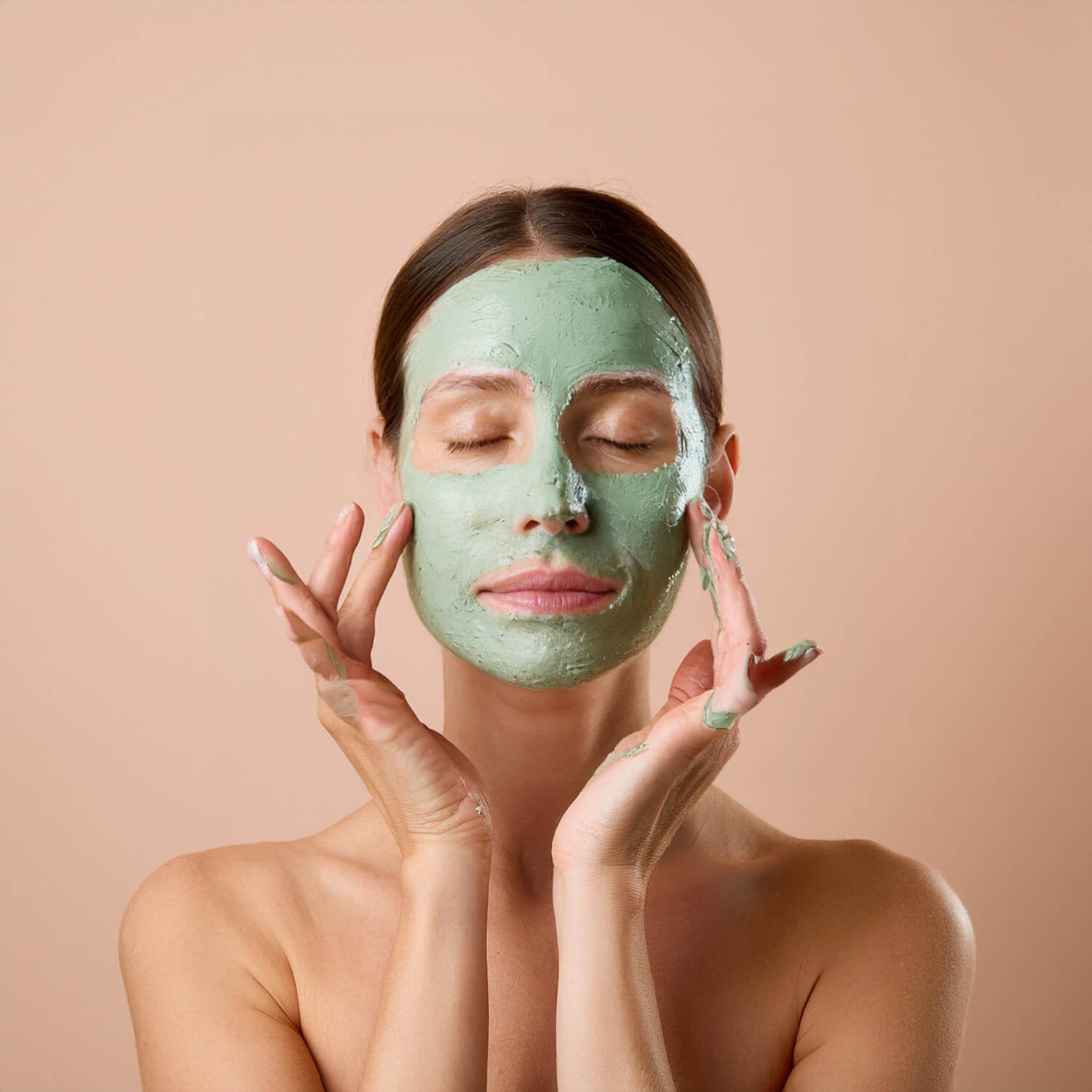 View of female hands applying balm to the face